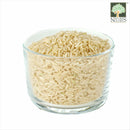 Nature's Glory organic fragrant long-grain brown rice in a clear glass bowl, showing the natural colour and texture of the grains.